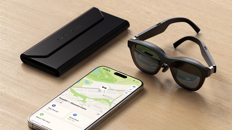 A Satechi FindAll glasses case on a wooden table next to glasses and an iPhone.
