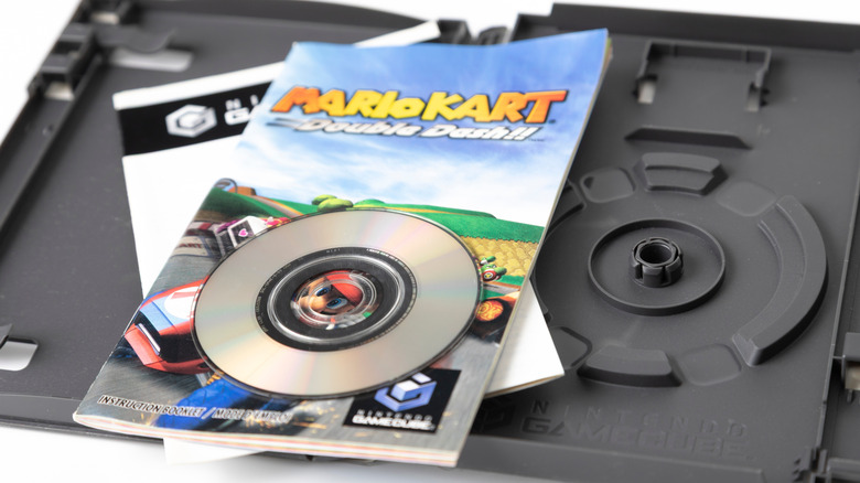 A Mario Kart Double Dash GameCube game disk sitting on its manual.