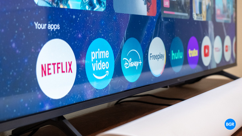 The Google TV home screen interface running on the TCL QM6K.