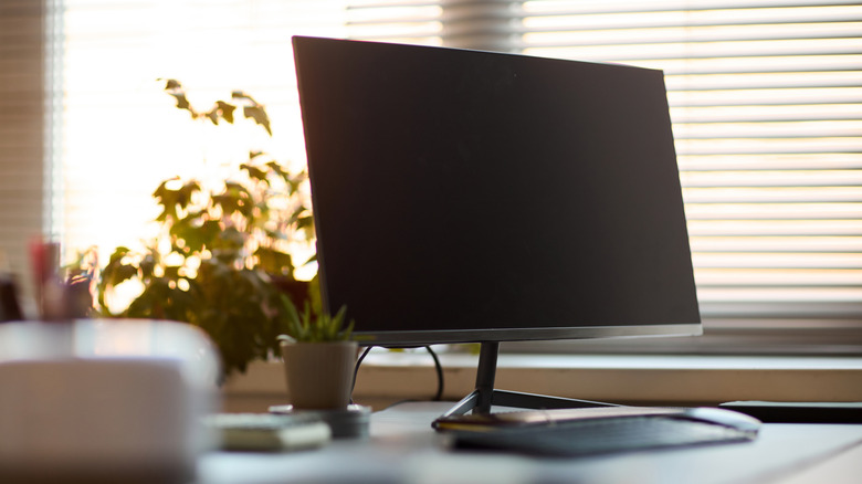 A modern computer monitor on an office desk suitable for Fire Stick connection.