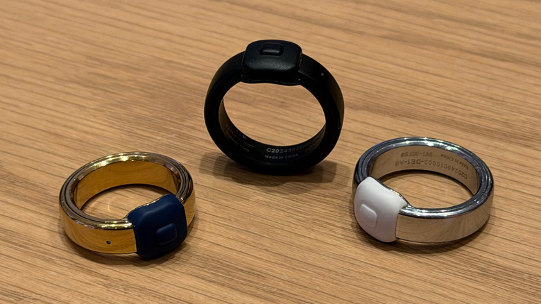Three Pebble Index 01 rings displayed in Polished Silver, Polished Gold, and Matte Black finishes.