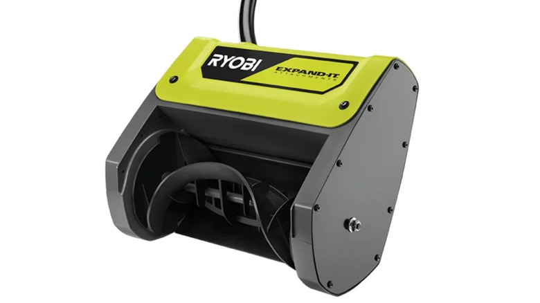 A close-up view of the Ryobi snow thrower attachment showing its plastic auger and intake.