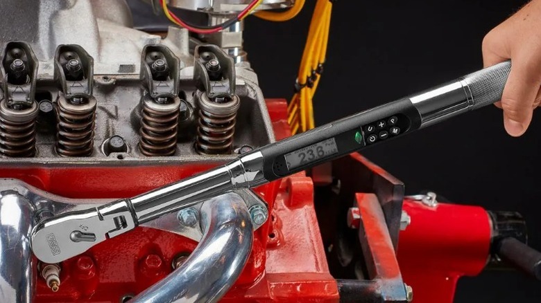 Mechanic applying torque to an engine component using the Icon 3/8-inch Drive Flex-Head Digital Angle Torque Wrench.