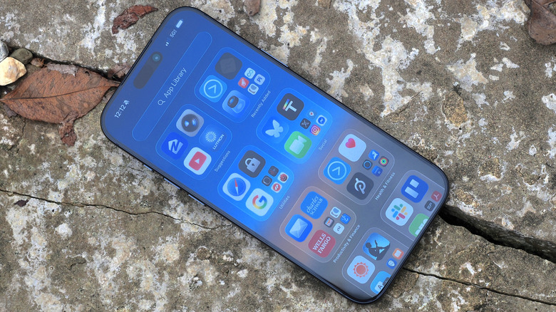 The iPhone 17 Pro Max screen displaying the iOS 26 home screen with colorful app icons.