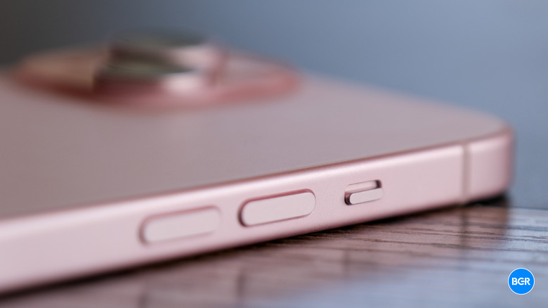 The side profile of the iPhone 15 focusing on the ringer switch.