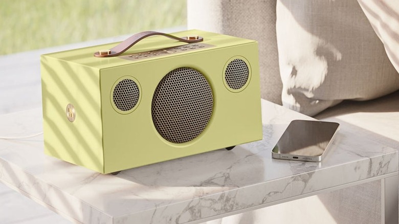 An Audio Pro C5 MkII W speaker placed on a minimalist side table.