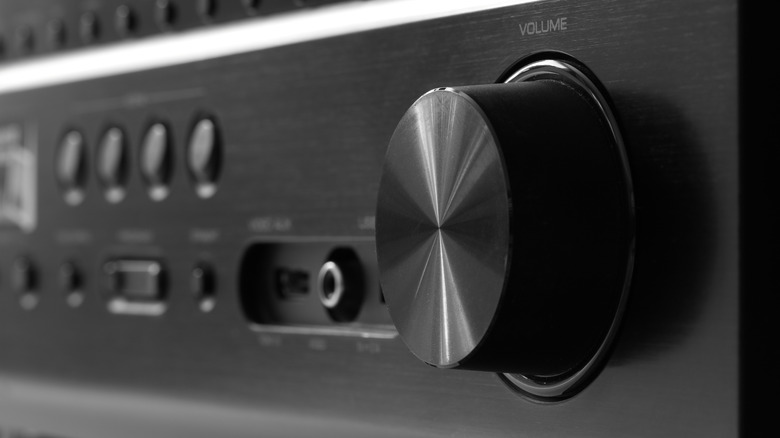 The illuminated front panel and display of a modern home theater AV receiver.