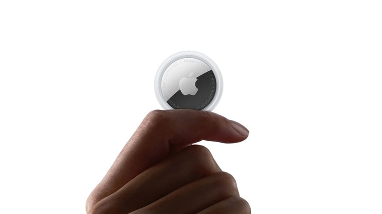 Close-up of a person holding the second-generation Apple AirTag.