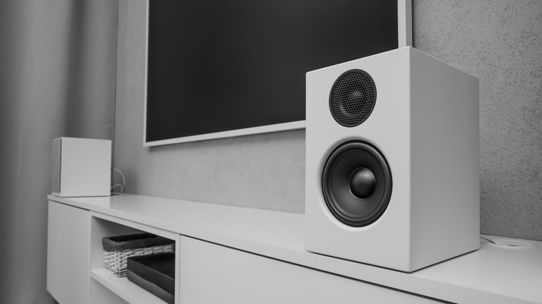 Two bookshelf speakers positioned on a TV stand, illustrating proper distance from the wall.