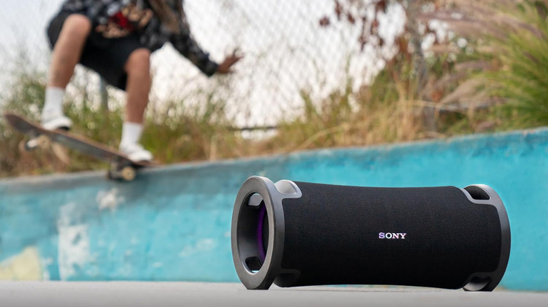 A Sony Ult Field 7 speaker sitting on a concrete ledge at an outdoor skate park