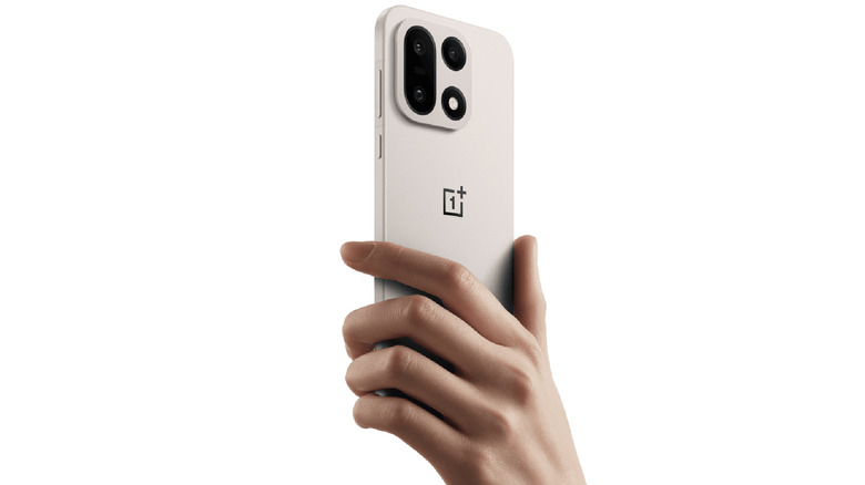 Close-up of a person holding the OnePlus 15