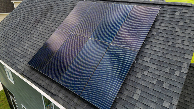 A wide shot of a rooftop solar panel system on a well-maintained home.